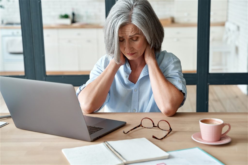 Stressed person at a laptop